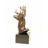 A bronze sculpture of a stag head