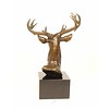 A bronze sculpture of a stag head