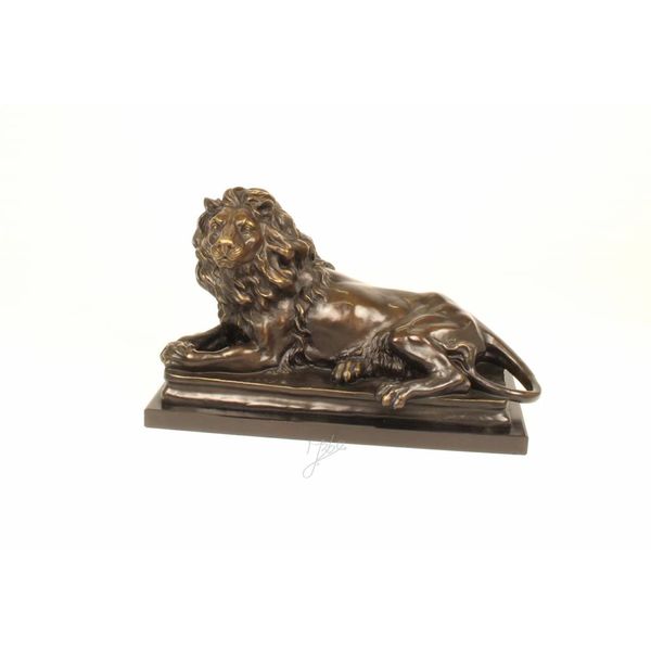  A bronze sculpture of a reclining lion (left)