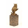 A bronze sculpture of a long-eared owl