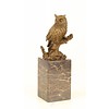 A bronze sculpture of a long-eared owl