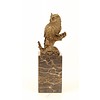 A bronze sculpture of a long-eared owl