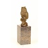 A bronze sculpture of a long-eared owl