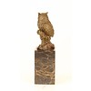 A bronze sculpture of a long-eared owl