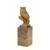 A bronze sculpture of a long-eared owl