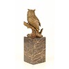 A bronze sculpture of a long-eared owl