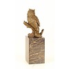 A bronze sculpture of a long-eared owl