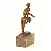 A bronze sculpture of two children playing leap-frog