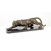 A bronze sculpture of a prowling panther
