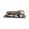 A bronze sculpture of a prowling panther