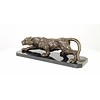 A bronze sculpture of a prowling panther