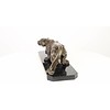 A bronze sculpture of a prowling panther