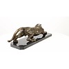 A bronze sculpture of a prowling panther