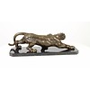 A bronze sculpture of a prowling panther