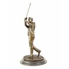 A bronze sculpture of a golfer in follow through stance