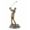 A bronze sculpture of a golfer in follow through stance