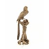 A bronze sculpture of a Macaw parrot perched on a branch