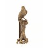 A bronze sculpture of a Macaw parrot perched on a branch