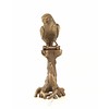 A bronze sculpture of a Macaw parrot perched on a branch