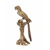 A bronze sculpture of a Macaw parrot perched on a branch