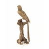 A bronze sculpture of a Macaw parrot perched on a branch