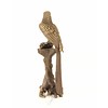 A bronze sculpture of a Macaw parrot perched on a branch