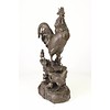 A bronze sculpture of a rooster, mother hen and chicks
