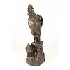 A bronze sculpture of a rooster, mother hen and chicks