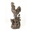 A bronze sculpture of a rooster, mother hen and chicks