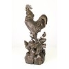 A bronze sculpture of a rooster, mother hen and chicks