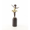 A bronze sculpture of a young ballerina