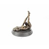 An erotic bronze sculpture of a naked female pleasing herself