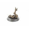 An erotic bronze sculpture of a naked female pleasing herself