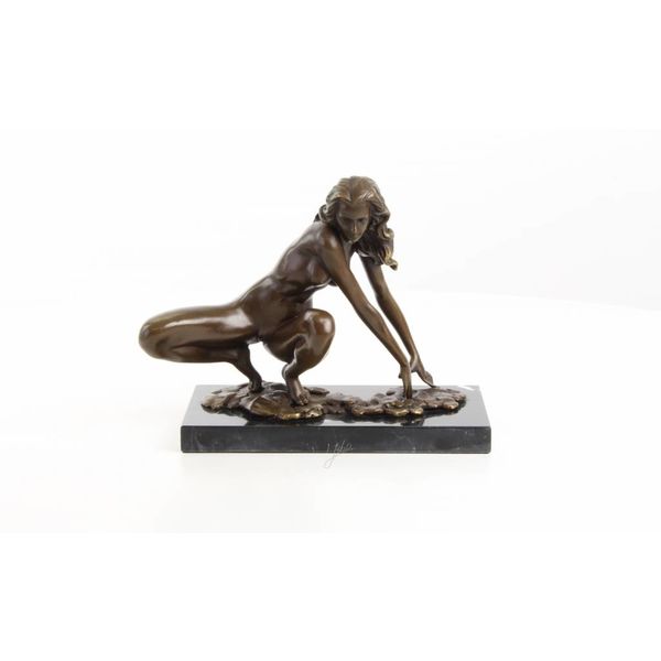  An erotic bronze sculpture of a female nude crouching