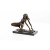 An erotic bronze sculpture of a female nude crouching