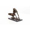 An erotic bronze sculpture of a female nude crouching