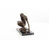 An erotic bronze sculpture of a female nude crouching