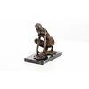 An erotic bronze sculpture of a female nude crouching