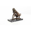 An erotic bronze sculpture of a female nude crouching