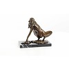 An erotic bronze sculpture of a female nude crouching