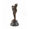 A  bronze sculpture of a boy playing the accordion