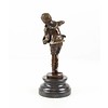 A  bronze sculpture of a boy playing the accordion