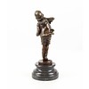 A  bronze sculpture of a boy playing the accordion