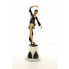 A large bronze sculpture of a graceful dancer with wooden inlay