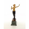 A bronze sculpture of a half nude female dancer with wooden inlay