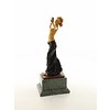 A bronze sculpture of a half nude female dancer with wooden inlay