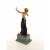 A bronze sculpture of a half nude female dancer with wooden inlay