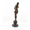 A large bronze sculpture of a pensive female