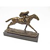 A bronze sculpture of a jockey and horse