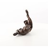 An erotic bronze sculpture of a nude female pleasing herself while lying down